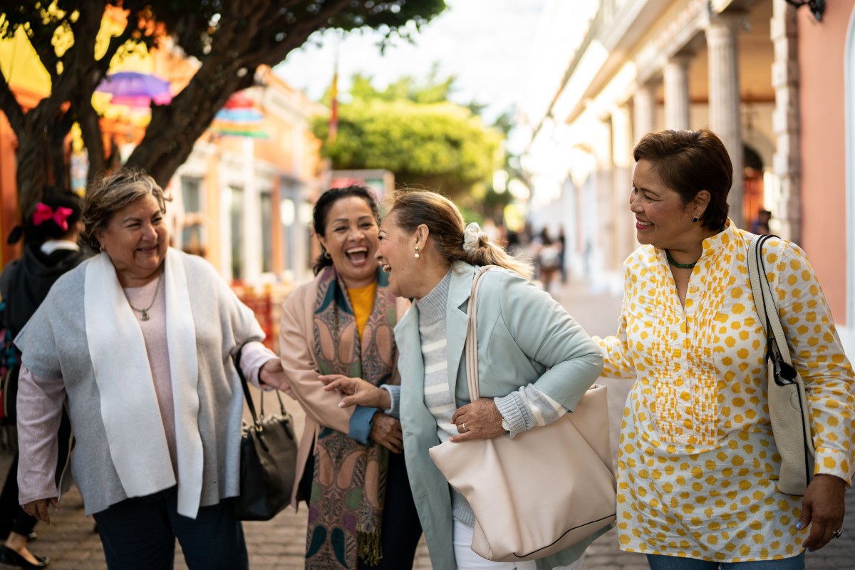 Senior friends talking and walking outdoors